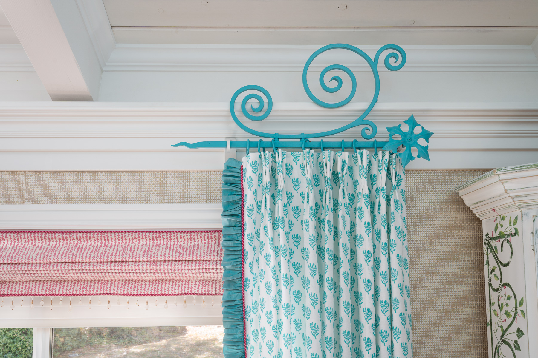 Detail of pink Roman shade and teal side panel