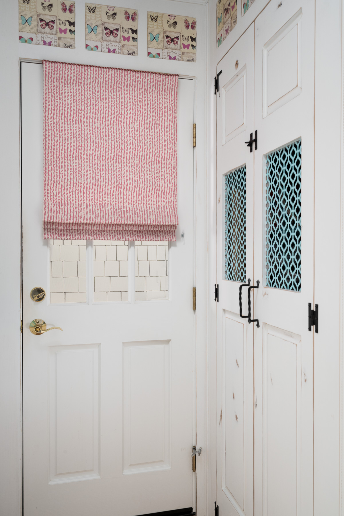 Hot pink ticking tape Roman shade on door