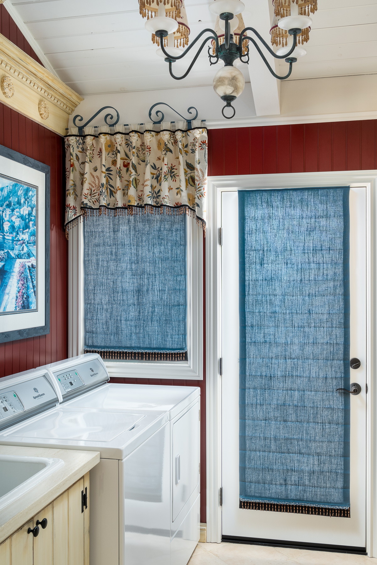 Blue roman shades in laundry room pulled down