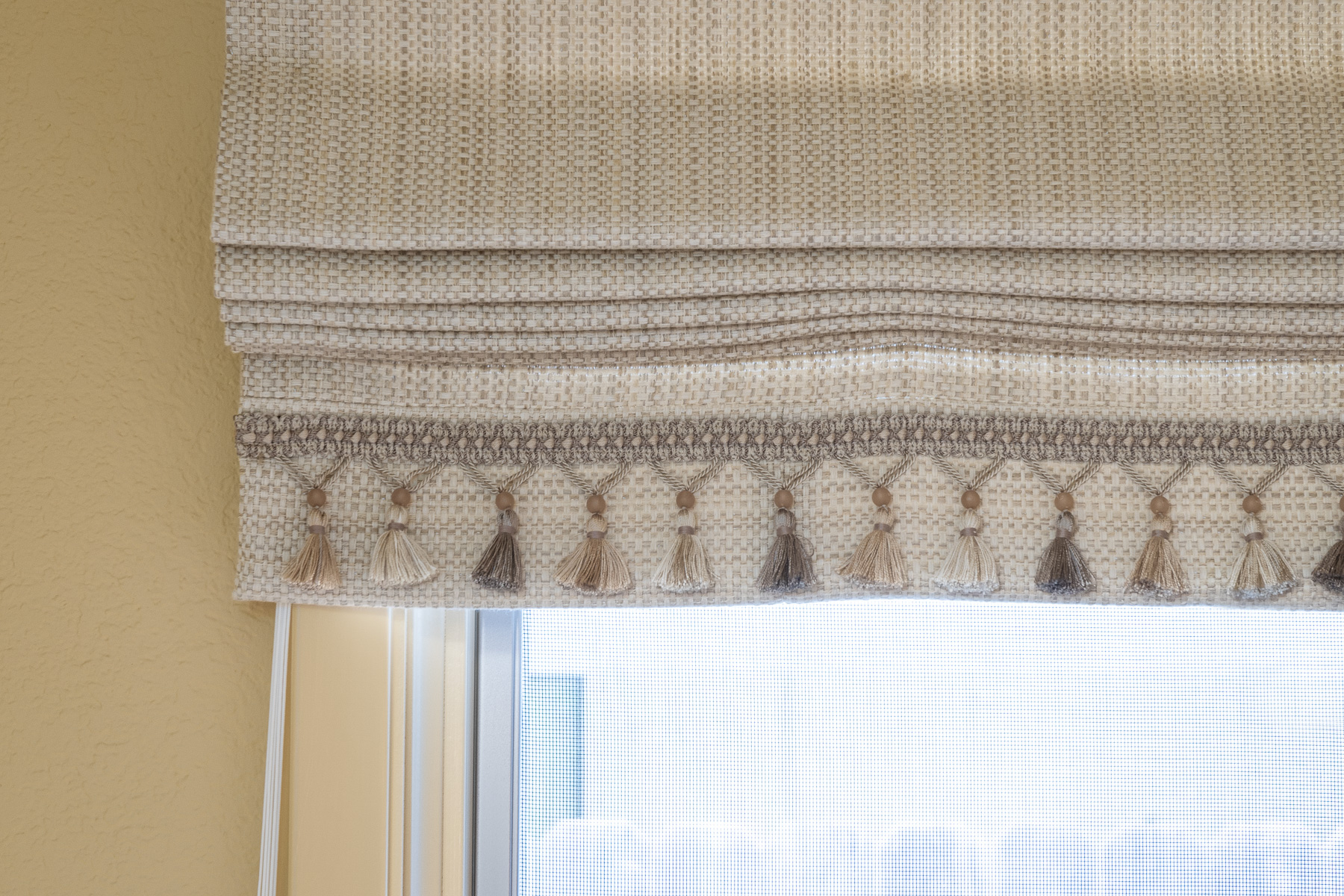 Tan Roman shade with sewn on tassels