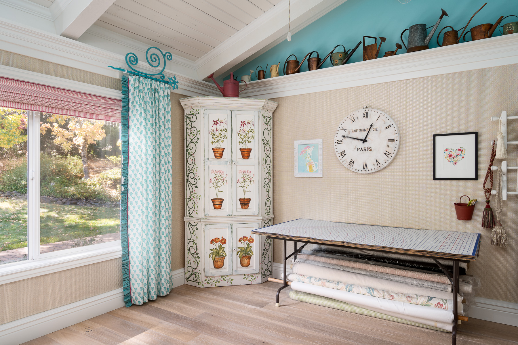 Roman shade with decorative teal panel